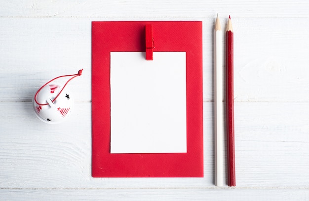 Blank red envelope, empty note on wooden rustic table.