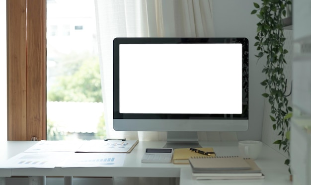 Blank screen desktop computer in minimal office room with decorations and copy spacexA