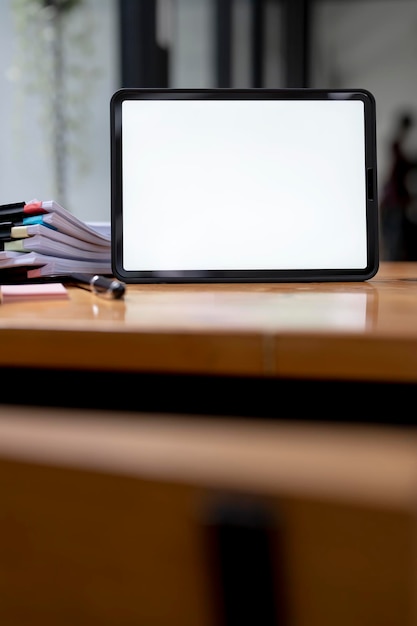 Blank screen digital tablet on wooden table vertical view Mockup creative workspace with digital tablet