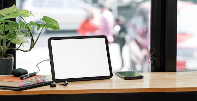 Blank screen digital tablet on wooden table