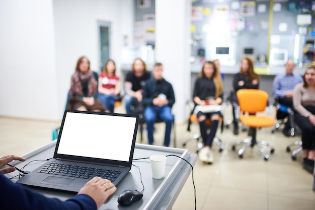 Blank screen laptop computer with blurred people on a background