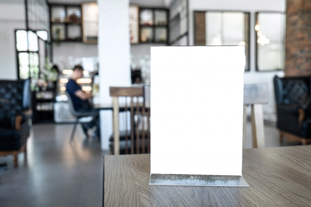 Blank screen mockup menu frame standing on wood table in background