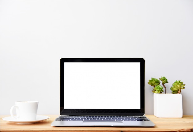 blank screen Modern laptop computer with mouse, Smartphone and Succulent on wood table