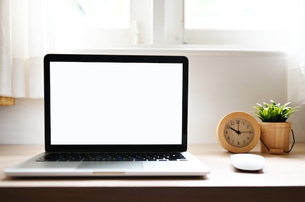 blank screen Modern laptop computer on wood table in Home office view backgrounds