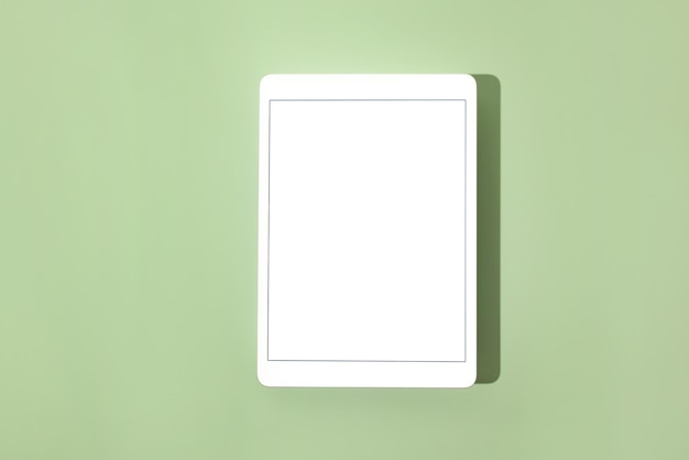 Blank screen tablet mock up and shadow on green pastel background Copy space Mock up template Business communication Isolated object Spring decoration