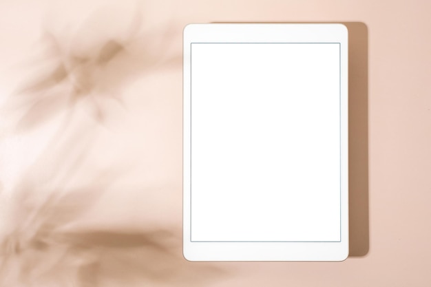 Blank screen tablet mock up and shadow on green pastel background Copy space Mock up template Business communication Isolated object Spring decoration