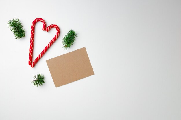 Blank sheet of paper and candy canes, Christmas card top view