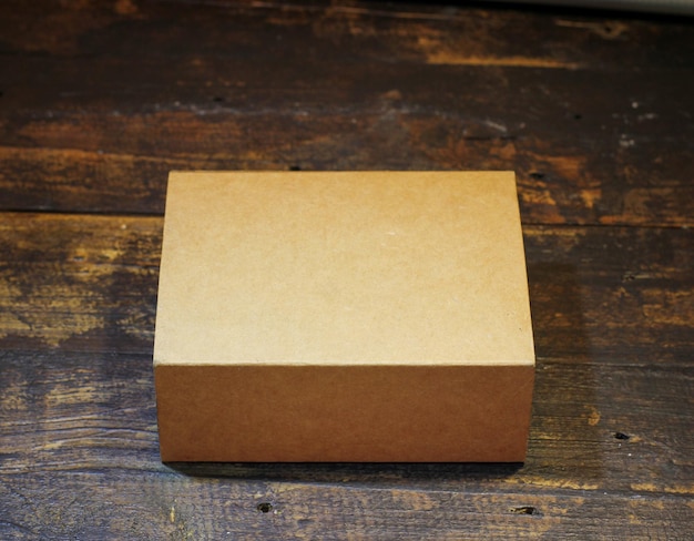 Blank Small Cardboard box on wooden background