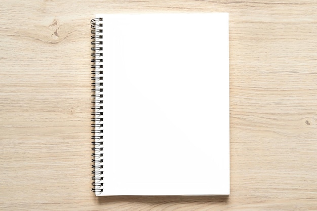 Blank spiral bound notepad mockup template with Kraft Paper cover isolated on wood background