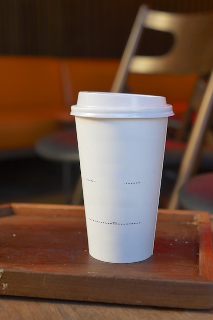 Blank take away kraft coffee cup on table