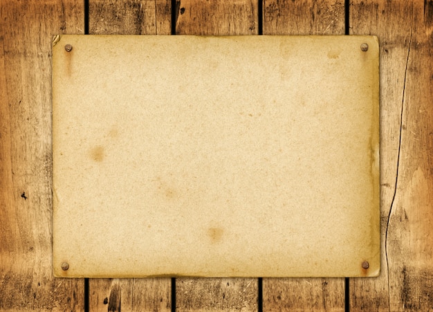 Blank vintage paper nailed on a wood board