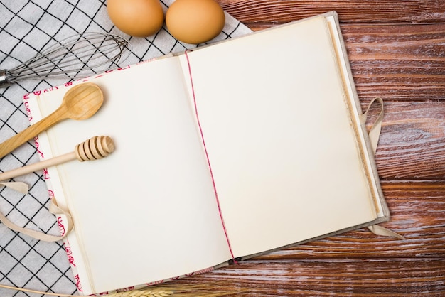 Photo blank vintage recipe book and on the wooden kitchen table closeup place for text top view