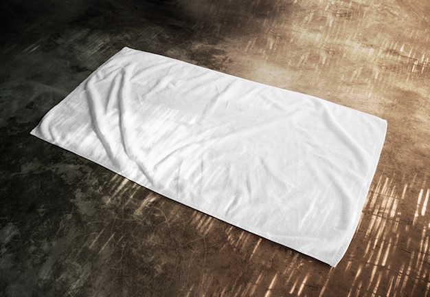 Blank white beach towel  on textured floor