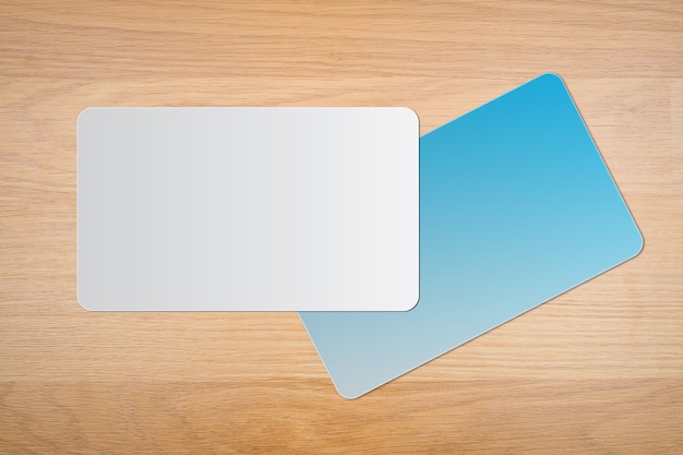 Blank white and blue business card on a wooden background. for text