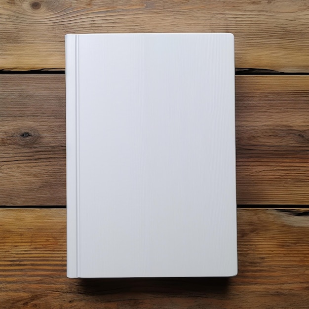 Blank white book cover top view on wood table