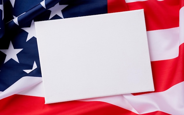 Blank white canvas frame for mockup design on american national flag background