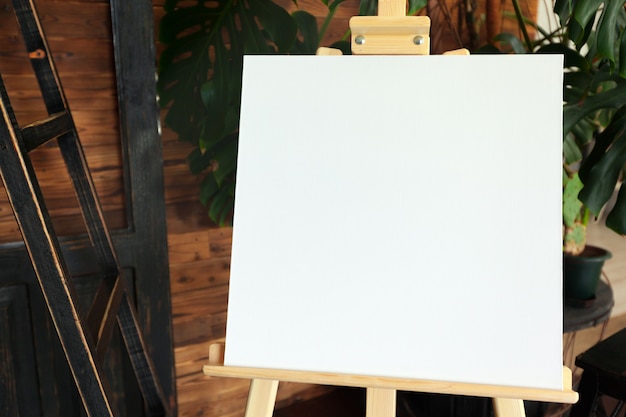 Blank white canvas on wooden easel