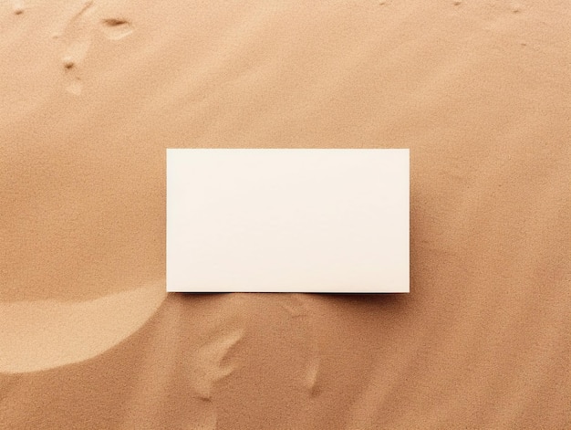 A blank white card on a sand dune