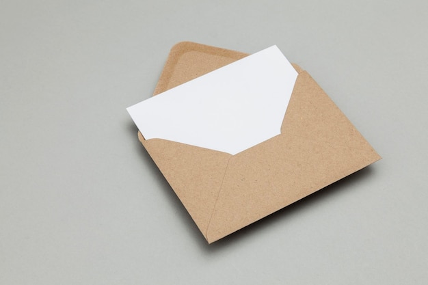 Blank white card with kraft brown paper envelope template mock up