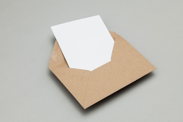 Blank white card with kraft brown paper envelope template mock up