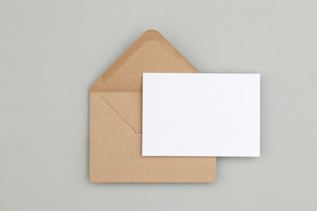 Blank white card with kraft brown paper envelope template mock up