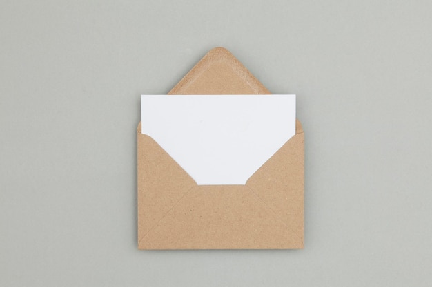 Blank white card with kraft brown paper envelope template mock up