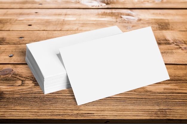 Blank white cards on wooden background