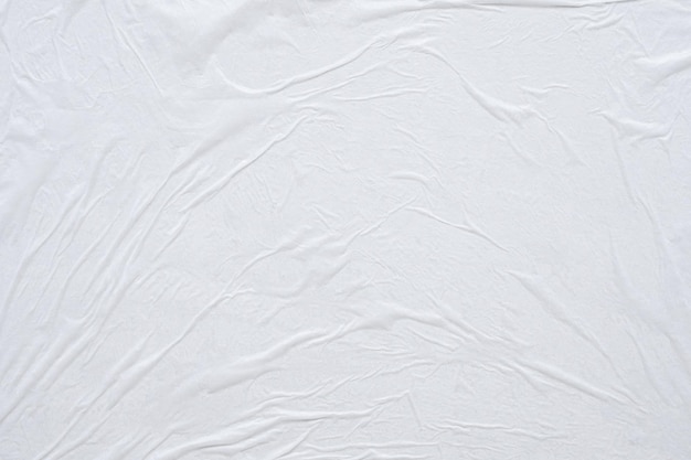 Blank white crumpled and creased paper poster texture background