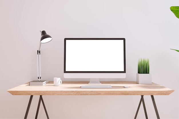 Blank white modern computer monitor on wooden table with coffee mug lamp and green plant in small pot on light wall background 3D rendering mock up