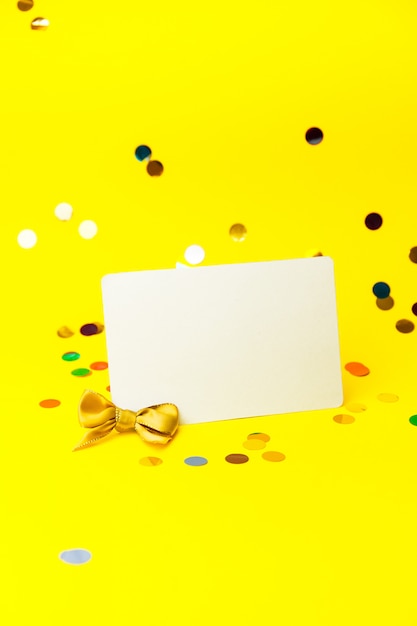 Blank White page mock up and sparkles confetti on Yellow.