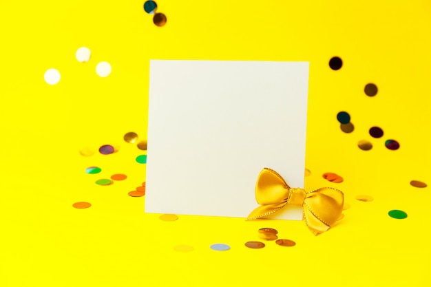 Blank White page mock up and sparkles confetti on Yellow.