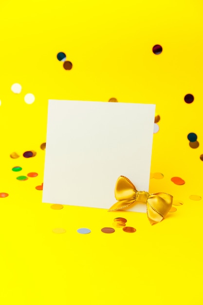 Blank White page mock up and sparkles confetti on Yellow.