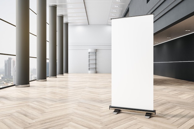 Blank white poster on wooden parquet floor in empty huge office hall with grey columns and city view from big window 3D rendering mock up