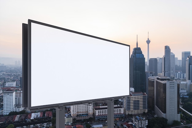 Blank white road billboard with Kuala Lumpur cityscape background at sunset Street advertising poster mock up 3D rendering Side view The concept of marketing communication to promote or sell idea