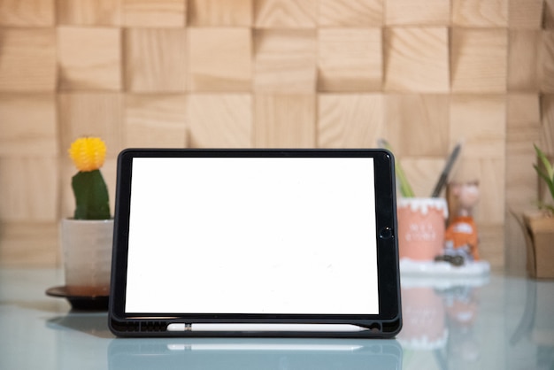 Blank white screen tablet computer on glass table