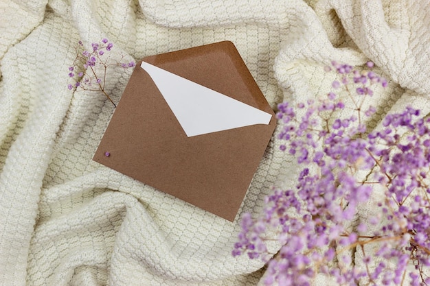 Blank white sheet in a craft envelope. Mockup of invitation and greeting card.