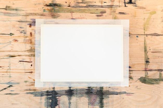 Blank white sheet of paper on wooden tablet