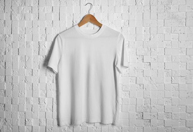 Blank white tshirt against light textured background