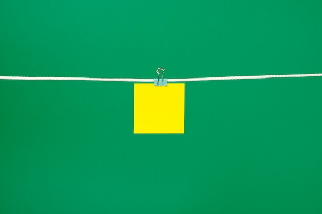 Blank yellow paper sheet on the string