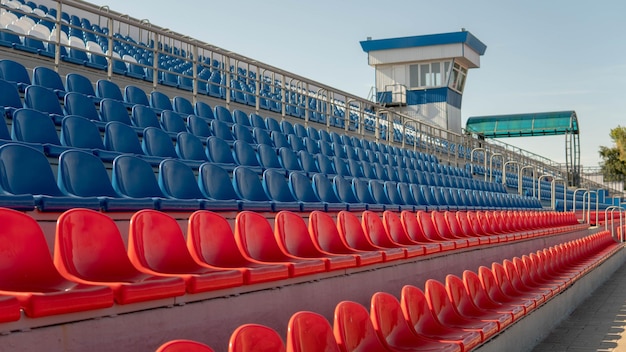 Bleachers in a sports stadium Red and blue seats in a large street stadium