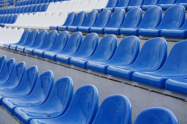 Bleachers in a sports stadium White and blue seats in a large street stadium