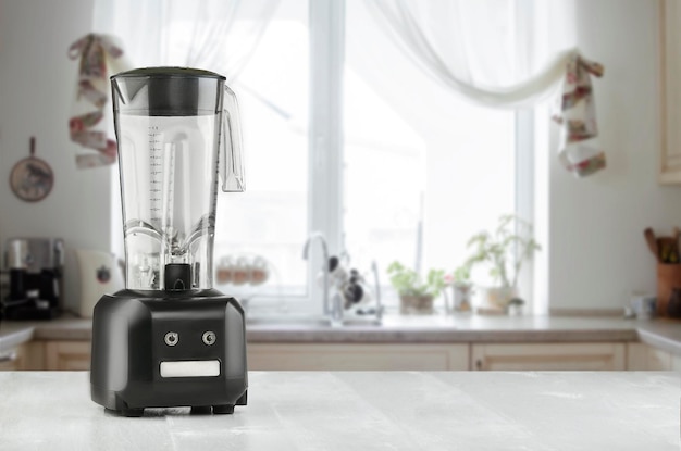 Blender and wooden table in kitchen. Do Smoothies