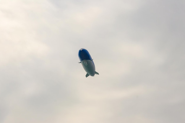 Blimp airship or dirigible flying in sky