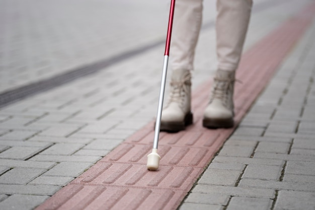 Blind person walking through the city with blind stick