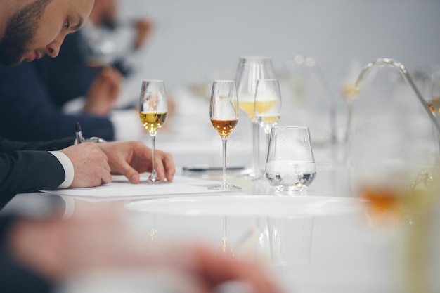 Blind tasting close up Sommelier makes notes on the tasting card