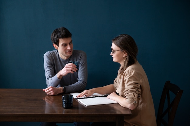 Blind woman reading  to a man using the braille language