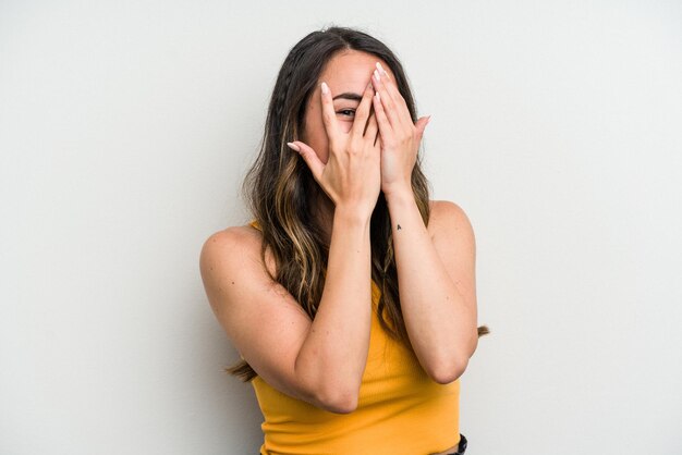 Blink at the camera through fingers embarrassed covering face