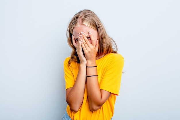 Blink at the camera through fingers embarrassed covering face