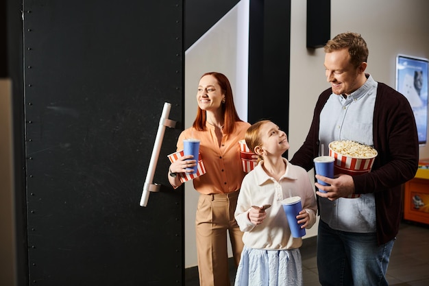 Blissful trio sharing popcorn delights