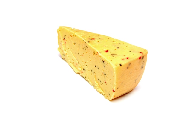 A block of cheese with a small red pepper on it